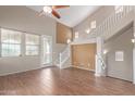 Bright and spacious living room with beautiful wood floors and staircase at 2854 N Claire Dr, Buckeye, AZ 85396