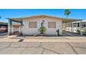 Charming single-story home with desert landscaping, carport, and decorative touches at 4065 E University -- # 433, Mesa, AZ 85202