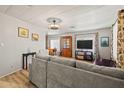 Open-concept living room with a gray sofa, dining area, and television at 4065 E University -- # 433, Mesa, AZ 85202