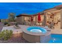 Beautiful backyard with a relaxing spa, built in BBQ, and a cozy fire pit at 42101 N Olympic Fields Ct, Anthem, AZ 85086