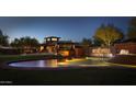 Night view of Anthem Country Club entrance with illuminated signage and water feature at 42101 N Olympic Fields Ct, Anthem, AZ 85086