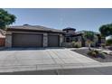 Beautiful home with a three car garage and stone accents at 42101 N Olympic Fields Ct, Anthem, AZ 85086