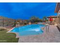 A gorgeous pool and spa are surrounded by desert landscaping at 42101 N Olympic Fields Ct, Anthem, AZ 85086