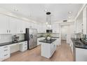 Bright kitchen featuring an island with granite countertops, stainless steel appliances, and white cabinetry at 4960 E Colonial Dr, Chandler, AZ 85249
