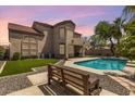 Beautifully landscaped backyard with a refreshing pool, artificial grass, and seating area at 5212 S Monte Vista St, Chandler, AZ 85249