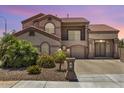 Stunning two-story home showcasing mature landscaping, a tile roof, and an iron gated entry at 5212 S Monte Vista St, Chandler, AZ 85249