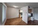 Open dining area with laminate floors, adjacent to the kitchen at 5446 W Sheena Dr, Glendale, AZ 85306