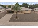 View of single-story home showcasing the well-maintained landscape, neutral tones, and convenient carport at 6217 E Dodge St, Mesa, AZ 85205