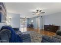 Spacious living area with laminate floors, a ceiling fan, and an adjacent dining space at 6217 E Dodge St, Mesa, AZ 85205