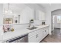 Bright kitchen boasts white cabinets, stainless steel appliances, and a large island for seamless food preparation and entertaining at 6359 S Forest Ave, Gilbert, AZ 85298