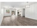 Bright, open living room with wood floors, ceiling fan, and sliding glass door to backyard at 6359 S Forest Ave, Gilbert, AZ 85298