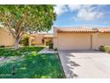 Well-kept home with a two-car garage, tiled roof, and a beautifully landscaped front yard with mature trees at 713 W Boxelder Pl, Chandler, AZ 85225