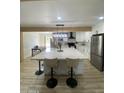 Modern kitchen showcasing a large island with seating and stainless steel appliances at 7201 N 16Th Dr, Phoenix, AZ 85021