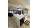 Bright kitchen features a large island with a farmhouse sink and stainless steel dishwasher at 7201 N 16Th Dr, Phoenix, AZ 85021