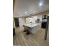 Open kitchen with a large island, modern lighting, and stainless steel appliances at 7201 N 16Th Dr, Phoenix, AZ 85021