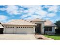 Charming single-story home with a three-car garage and a tiled roof at 7344 E Flower Ave, Mesa, AZ 85208