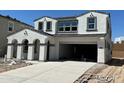 Modern two-story home with a spacious driveway leading to an attached garage, bathed in bright sunlight at 7392 W Buckhorn Trl, Peoria, AZ 85383