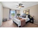 Cozy bedroom with a ceiling fan, a comfortable queen-size bed, and a large window offering natural light at 811 E Eugie Ave, Phoenix, AZ 85022