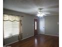 Inviting living room features hardwood floors, a ceiling fan and a window with charming valance at 8334 N 55Th Ave, Glendale, AZ 85302