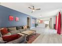 Open-concept living area with ample seating, stylish decor, and a seamless transition into the dining and kitchen spaces at 897 E Cherry Hills Dr, Chandler, AZ 85249