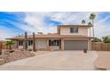 Inviting front elevation view of home with two-car garage and drought-tolerant landscaping at 9803 N 40Th Dr, Phoenix, AZ 85051