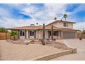 Charming home featuring a two-car garage, desert landscaping, and mature trees at 9803 N 40Th Dr, Phoenix, AZ 85051
