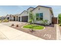 Inviting home featuring a landscaped front yard with desert accents at 10447 W Salter Dr, Peoria, AZ 85382