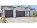 Three-car garage and large driveway, providing ample parking space at 10447 W Salter Dr, Peoria, AZ 85382
