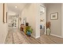 Elegant hallway featuring wood-look tile flooring and tasteful decor at 10447 W Salter Dr, Peoria, AZ 85382