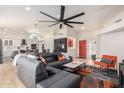 Bright living room featuring vaulted ceiling, hardwood floors, and a view into the adjacent kitchen at 13918 N 78Th Ave, Peoria, AZ 85381