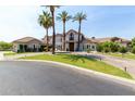 Beautiful two-story home with lush landscaping, green lawn and a circular driveway at 1502 E Treasure Cove Dr, Gilbert, AZ 85234