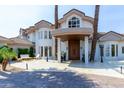 Stately luxury home with porte cochere and lush landscaping at 1502 E Treasure Cove Dr, Gilbert, AZ 85234