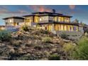 Hillside property boasting a modern exterior, stone facade, an attached guest house and ample outdoor spaces at 16119 N Desert Fox Pkwy, Fountain Hills, AZ 85268