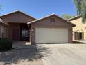 Charming single-story home featuring a 2-car garage and low-maintenance desert landscaping at 1930 W Burgess Ln, Phoenix, AZ 85041