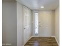 Bright foyer with wood-look tile flooring and neutral walls leading to the main living areas at 2046 E Downing St, Mesa, AZ 85213