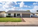 Well-maintained single-Gathering home featuring a lush green lawn and spacious two-car garage at 2418 E Hermosa Dr, Tempe, AZ 85282