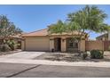 Charming single-story home featuring a two-car garage, front yard landscaping, and desert rock at 24229 W Tonto St, Buckeye, AZ 85326