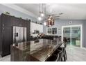 Spacious kitchen features a large island with bar seating, modern appliances, and pendant lighting at 24648 N 40Th Ln, Glendale, AZ 85310