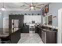 Gourmet kitchen with stainless steel appliances, granite countertops, and ample cabinet space at 24648 N 40Th Ln, Glendale, AZ 85310