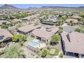 Beautiful home with a private pool, putting green, and serene desert views from this aerial shot at 30374 N 124Th Dr, Peoria, AZ 85383