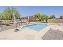 A sparkling private pool is nestled within a low-maintenance desert landscape and green putting green at 30374 N 124Th Dr, Peoria, AZ 85383