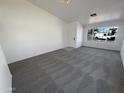 Spacious living room features large windows and neutral carpet throughout at 3407 N 67Th Ln, Phoenix, AZ 85033