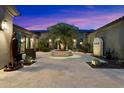 Beautifully lit courtyard with desert landscaping and stone pavers, perfect for entertaining at 36133 N 24Th Ave, Phoenix, AZ 85086