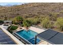 Backyard oasis featuring a sparkling pool, spa, outdoor kitchen, fireplace and desert views at 36133 N 24Th Ave, Phoenix, AZ 85086