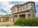 Charming two-story home with a well-manicured lawn, stone accents, and a two-car garage at 3938 E Appaloosa Rd, Gilbert, AZ 85296