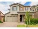 Charming two-story home with a well-manicured lawn, stone accents, and a two-car garage at 3938 E Appaloosa Rd, Gilbert, AZ 85296