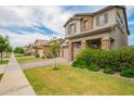 Charming two-story home with a well-manicured lawn, stone accents, and a two-car garage at 3938 E Appaloosa Rd, Gilbert, AZ 85296