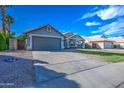 Well-maintained single-Gathering home boasts an oversized driveway and desert landscaping for low maintenance at 4050 E Encinas Ave, Gilbert, AZ 85234