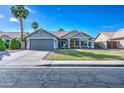 Inviting single-story home featuring a two-car garage, desert landscaping, and a well-manicured front yard at 4050 E Encinas Ave, Gilbert, AZ 85234