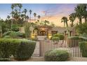 Charming property featuring a private bridge leading to a stone façade and lush, mature landscaping at 4836 E Moonlight Way, Paradise Valley, AZ 85253